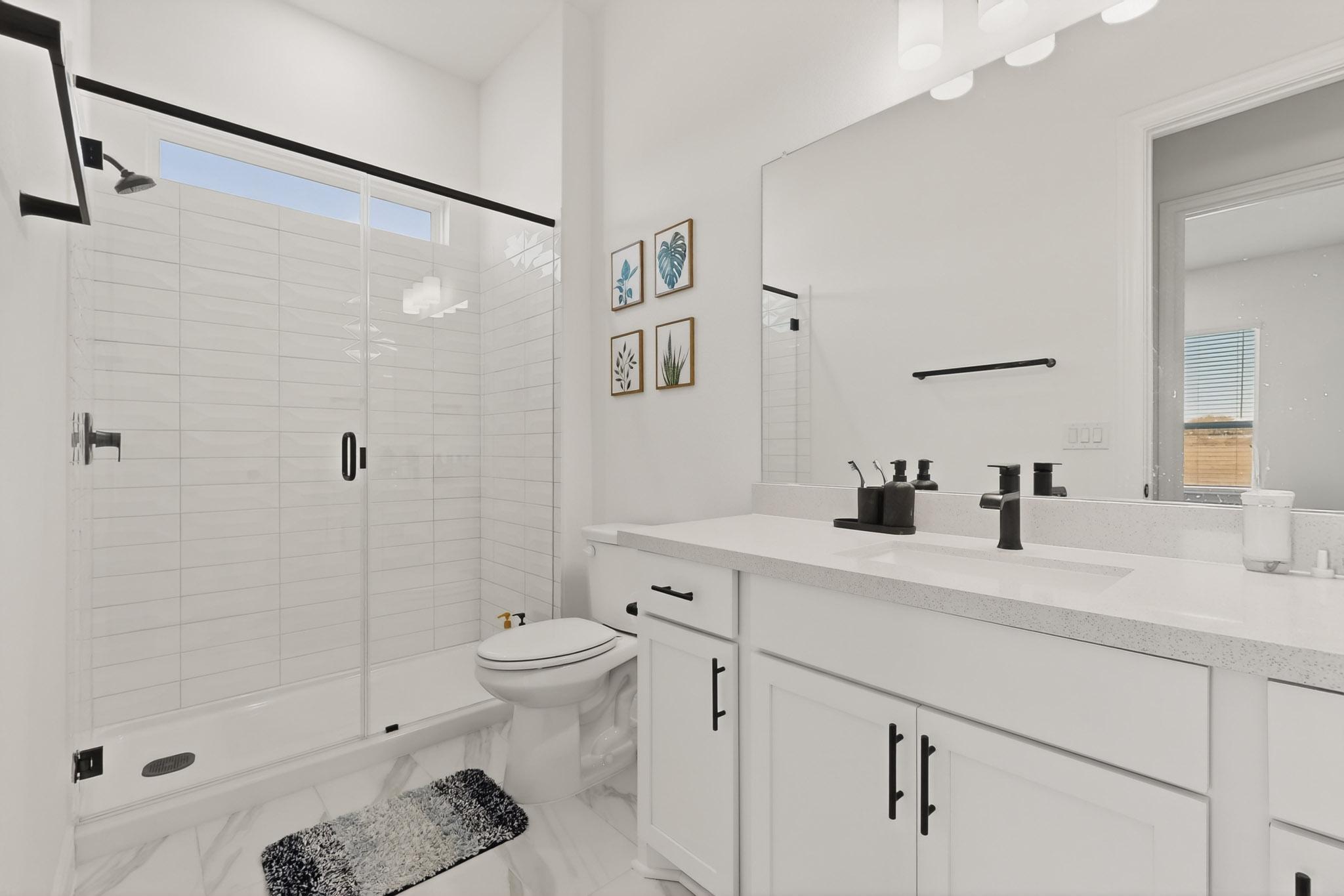2121 Lolo Lane Leander, TX 78641 - Photo 18 of 26 Bathroom featuring vanity and a shower stall