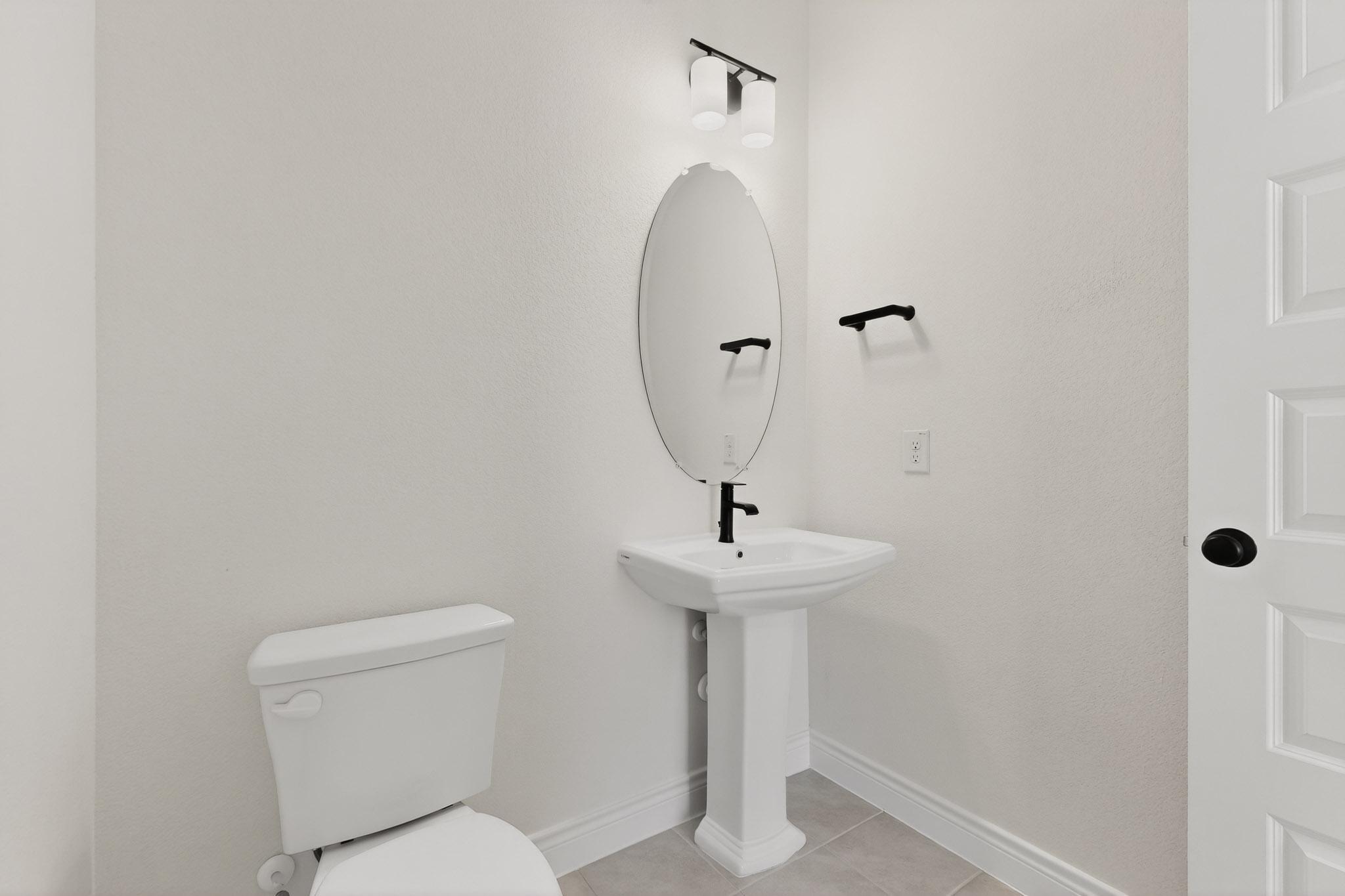 2121 Lolo Lane Leander, TX 78641 - Photo 21 of 26 Bathroom with toilet and light tile patterned floors