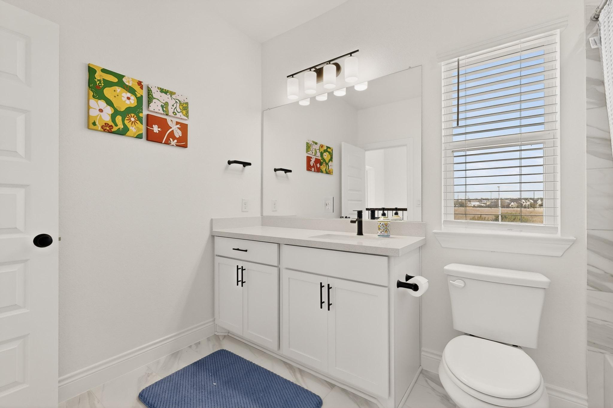 2121 Lolo Lane Leander, TX 78641 - Photo 23 of 26 Bathroom featuring vanity and baseboards