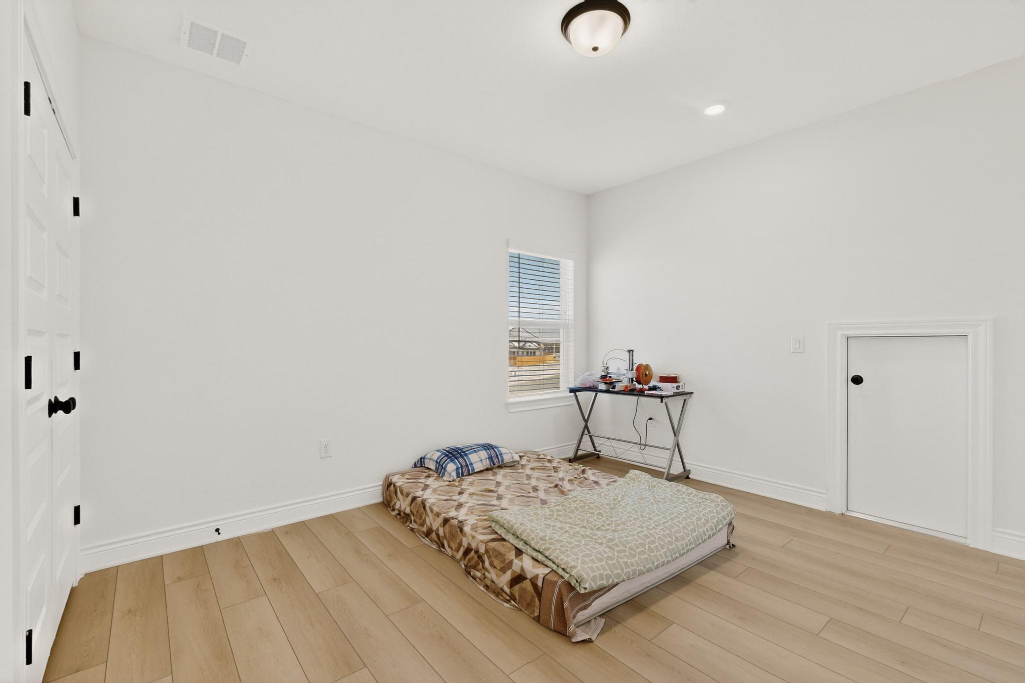 2121 Lolo Lane Leander, TX 78641 - Photo 24 of 26 Bedroom featuring light wood-style floors, a closet, and recessed lighting