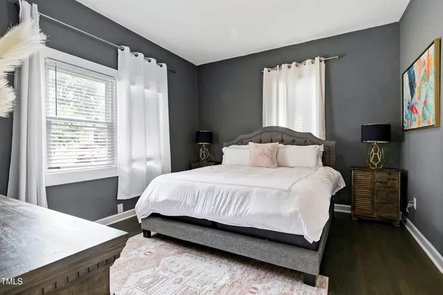 a bedroom with a bed and a television