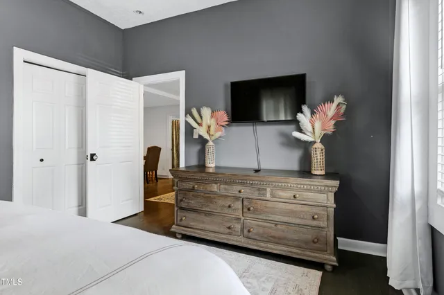 a en suite bathroom with a granite countertop toilet sink and a mirror
