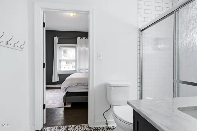 a bathroom with a sink a toilet and a mirror