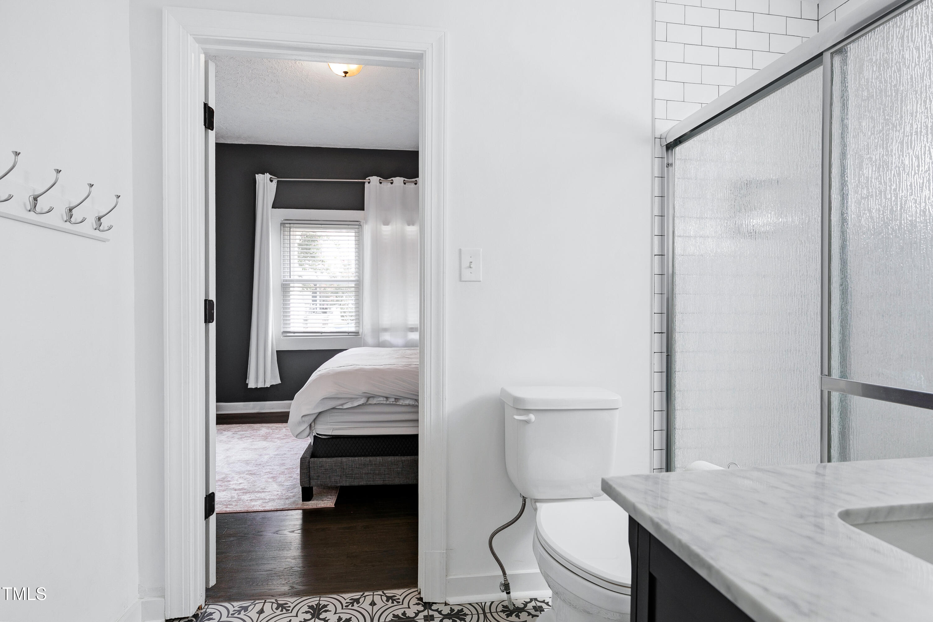320 East Cabarrus Street Raleigh, NC 27601 - Photo 17 of 30 a en suite bathroom with a granite countertop toilet sink and a mirror