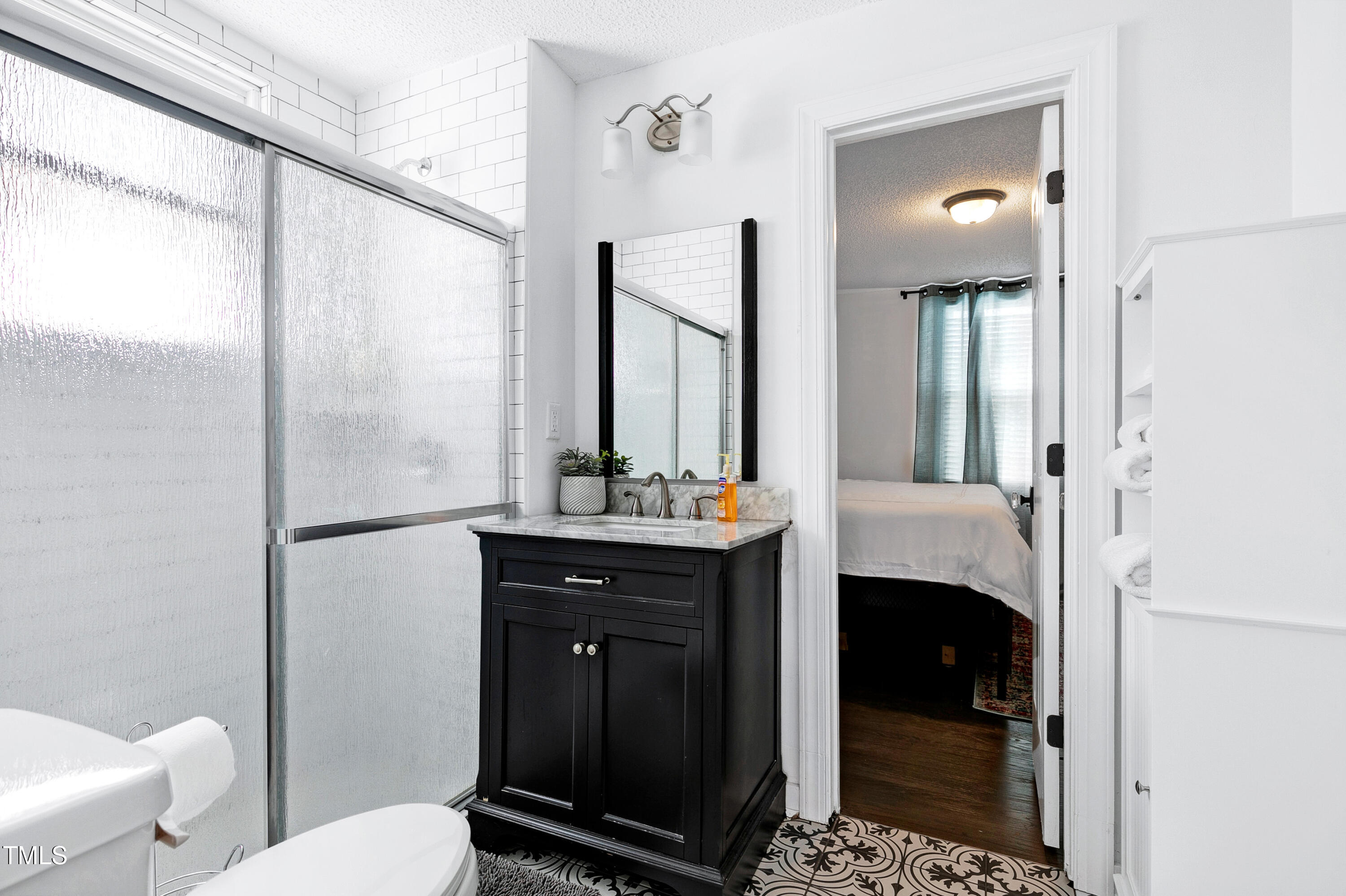 320 East Cabarrus Street Raleigh, NC 27601 - Photo 18 of 30 a bathroom with a sink a toilet and a mirror