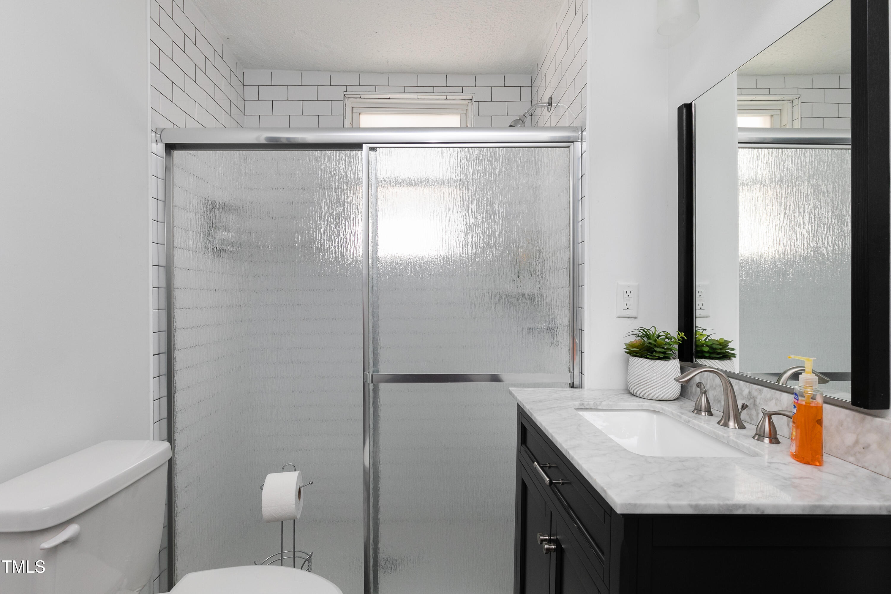 320 East Cabarrus Street Raleigh, NC 27601 - Photo 19 of 30 a bathroom with a granite countertop sink toilet and shower