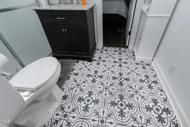 a bedroom with a bed wooden floor and window