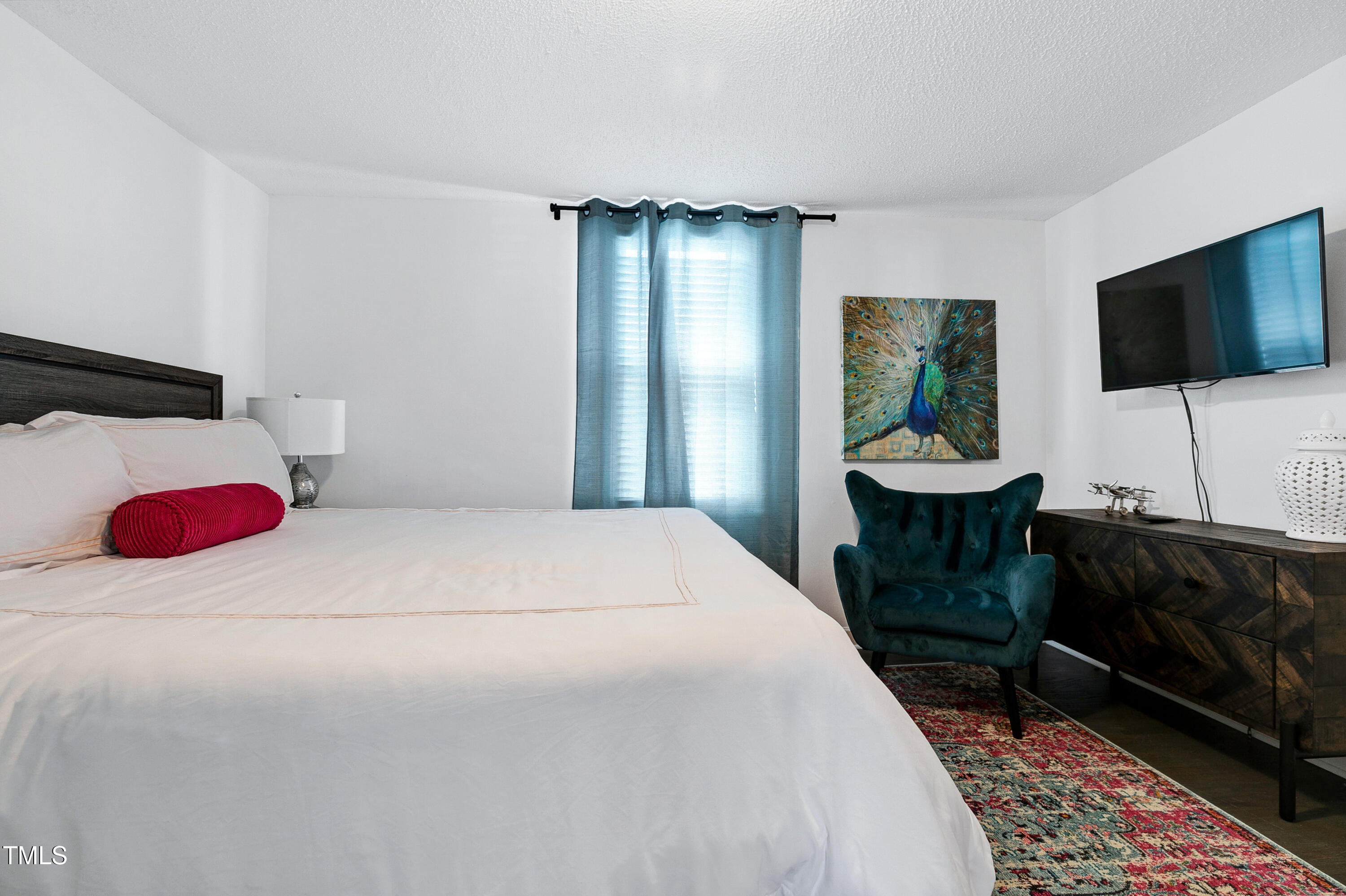 320 East Cabarrus Street Raleigh, NC 27601 - Photo 23 of 30 a bedroom with a bed and a flat screen tv