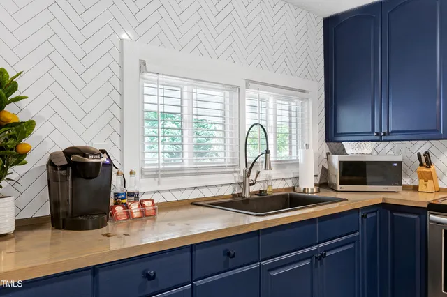 a kitchen with a sink appliances and cabinets