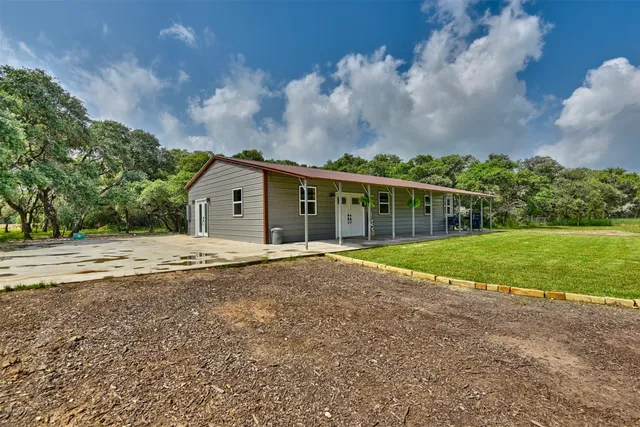 a view of house with yard and entertaining space