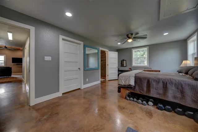 a bedroom with a large bed and a chandelier