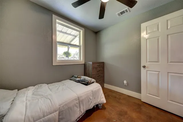 a bedroom with a bed and a window