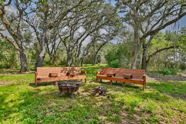 a backyard of a house with yard and outdoor seating