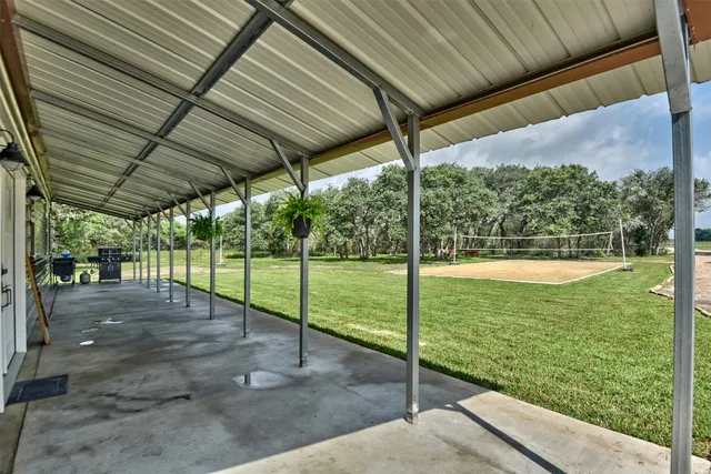 a view of swimming pool with outdoor seating and yard in back