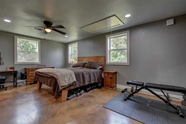 a bedroom with a bed a desk and chair