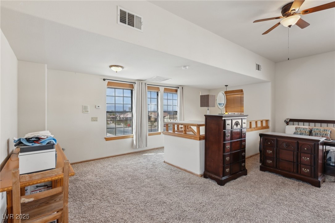 519 North Racetrack Road Henderson, NV 89015 - Photo 67 of 98 Kitchen with light carpet, ceiling fan, visible vents, and baseboards