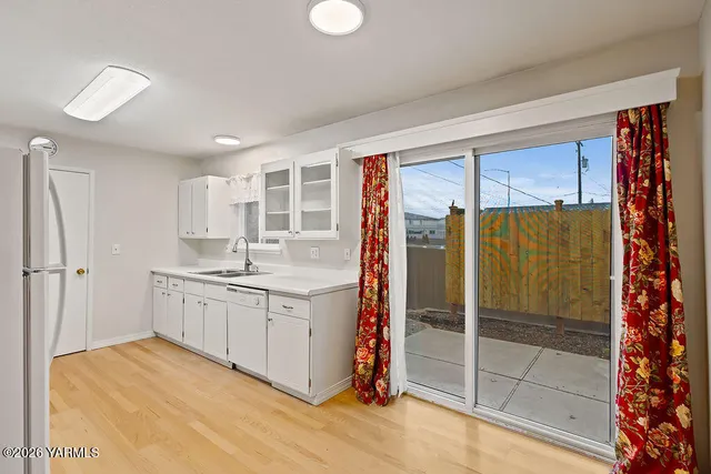 a bathroom with a granite countertop sink a mirror and shower