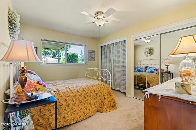 a bedroom with a bed and a painting on the wall