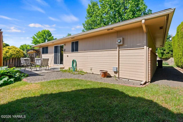 a view of a backyard with plants and a patio