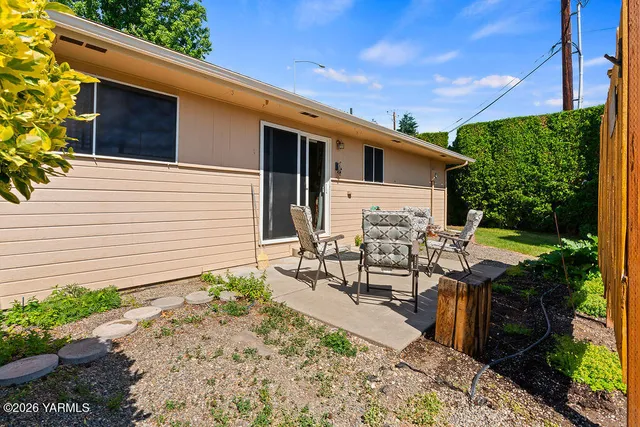 a view of a patio with table and chairs and potted plants