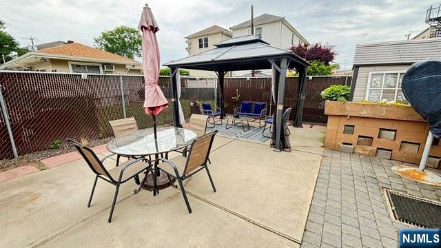 760 Hamilton Street, Unit 1 Harrison, NJ 07029 - Photo 21 of 23 a view of a patio with a table and chairs under an umbrella