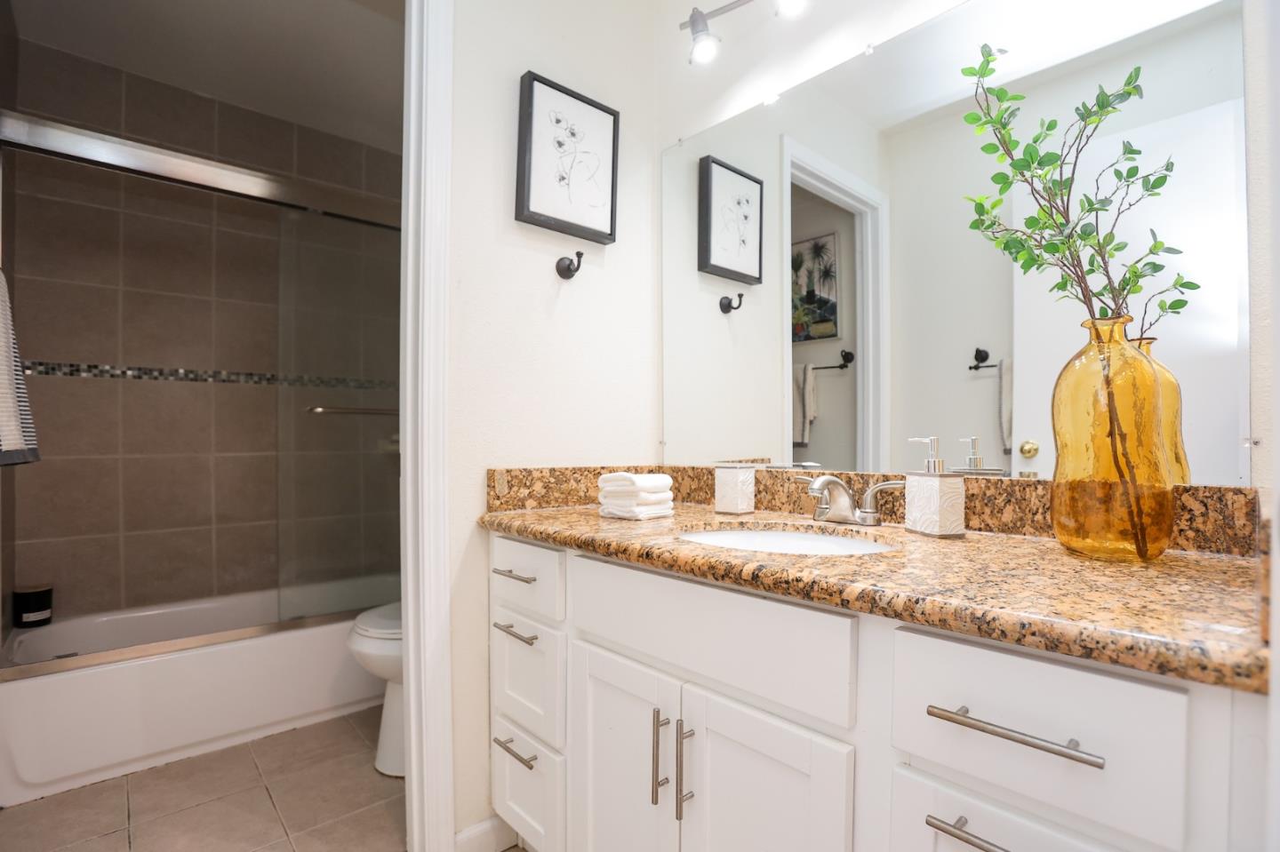 274 Stonegate Circle San Jose, CA 95110 - Photo 16 of 28 a bathroom with a granite countertop sink a toilet and bathtub