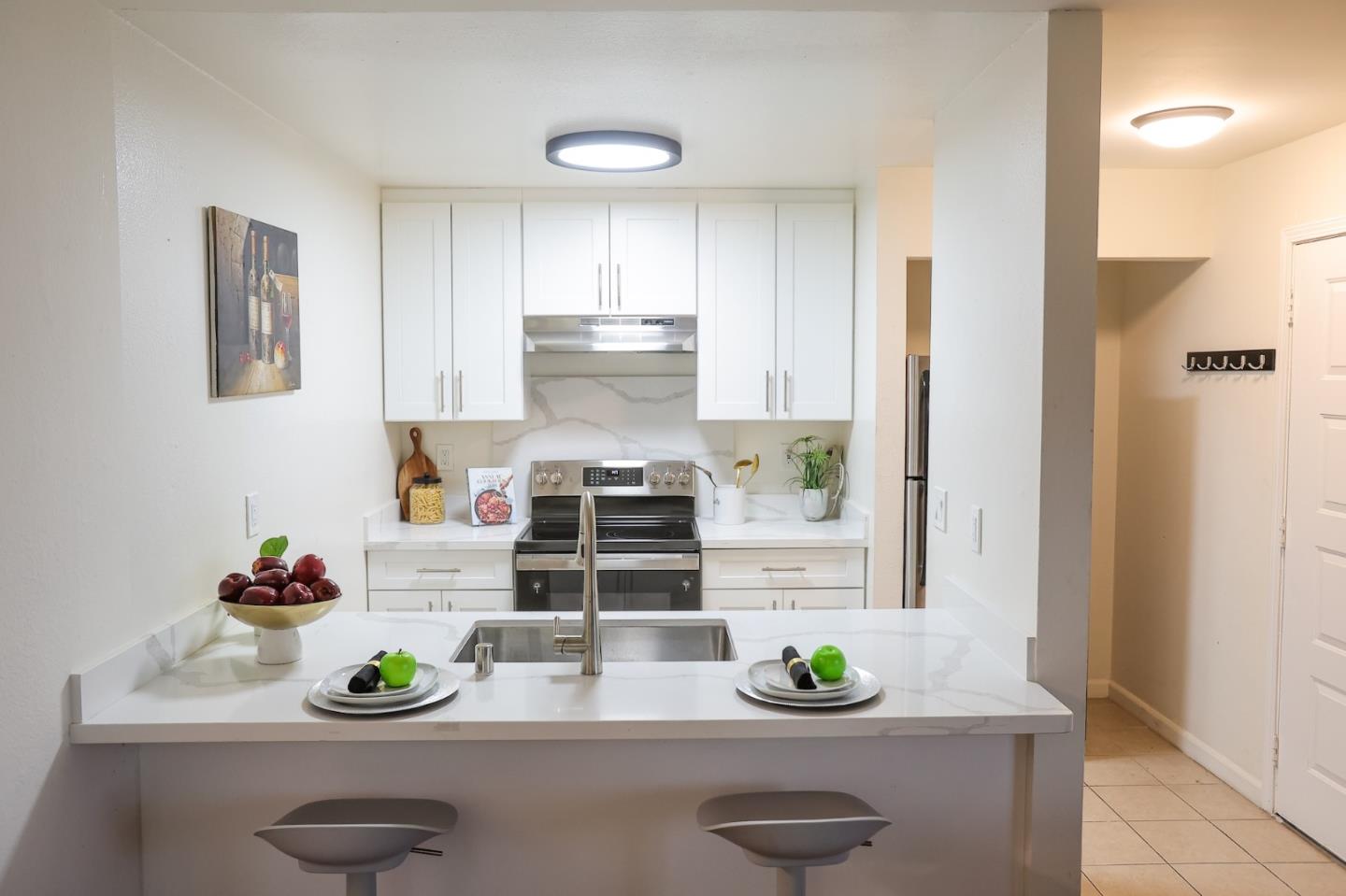 274 Stonegate Circle San Jose, CA 95110 - Photo 6 of 28 a kitchen with white cabinets and appliances