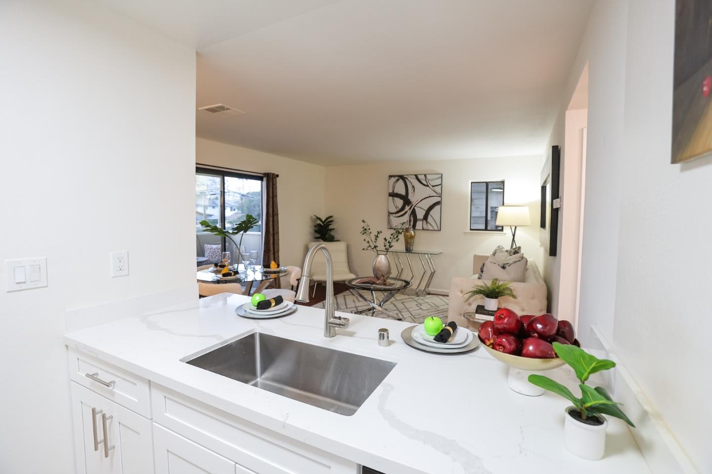 274 Stonegate Circle San Jose, CA 95110 - Photo 8 of 28 a kitchen with a sink and flowers