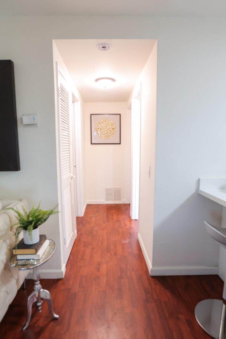 274 Stonegate Circle San Jose, CA 95110 - Photo 10 of 28 a view of a hallway with wooden floor and a potted plant