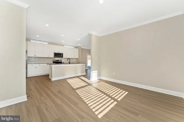a view of kitchen with wooden floor and electronic appliances