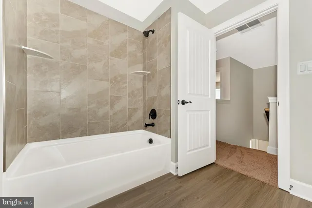 a bathroom with a bathtub and a shower