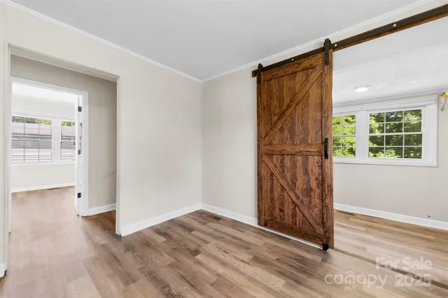 a view of front door with wooden floor and stairs
