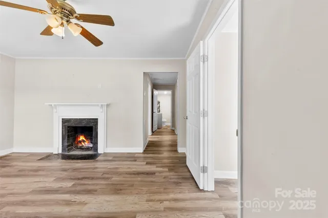 a view of a livingroom with wooden floor and a fireplace