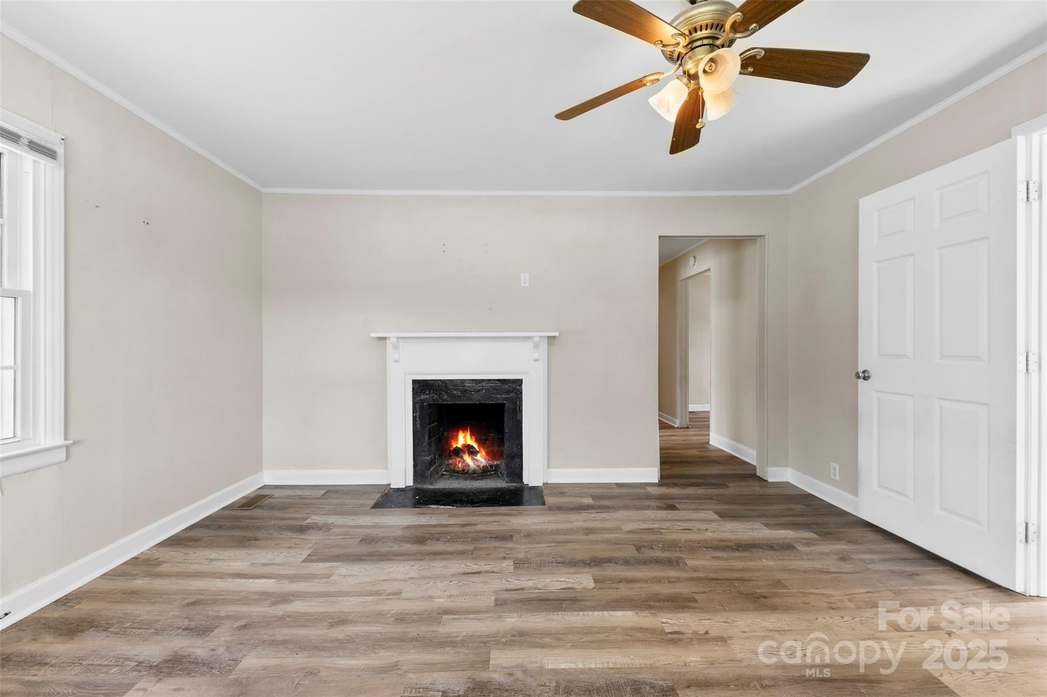 2009 Auten Road Gastonia, NC 28054 - Photo 22 of 30 an empty room with wooden floor a ceiling fan and fireplace