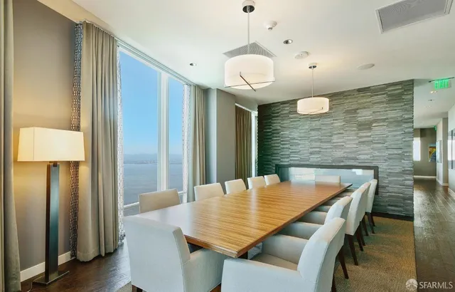 a dining room with furniture and wooden floor