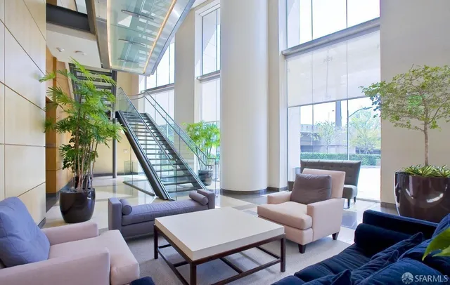 a living room with furniture and a potted plant