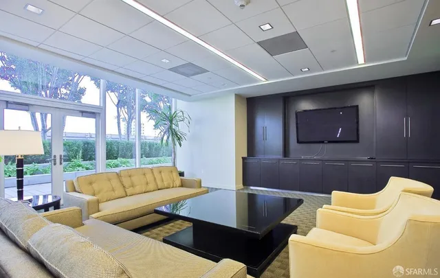 a living room with furniture and a floor to ceiling window