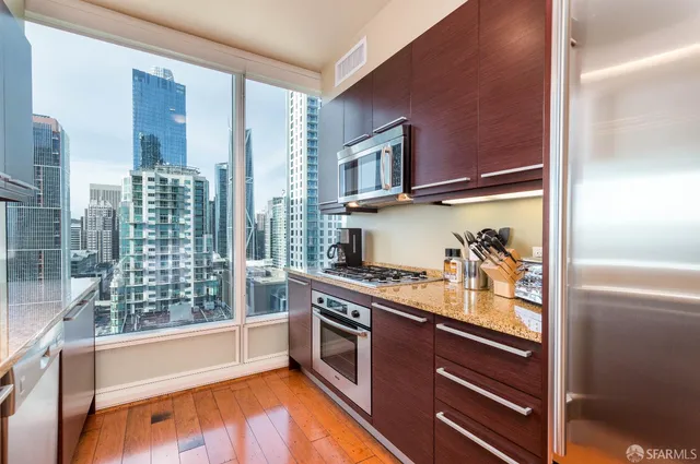 a kitchen with stainless steel appliances granite countertop a stove and a refrigerator