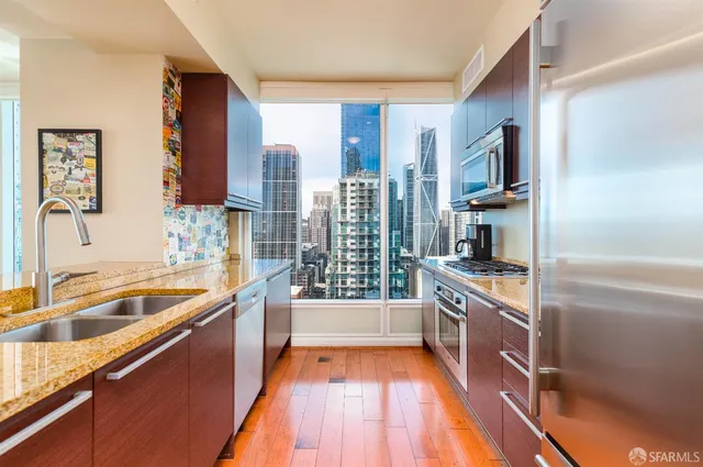 a kitchen with stainless steel appliances granite countertop a sink stove and refrigerator