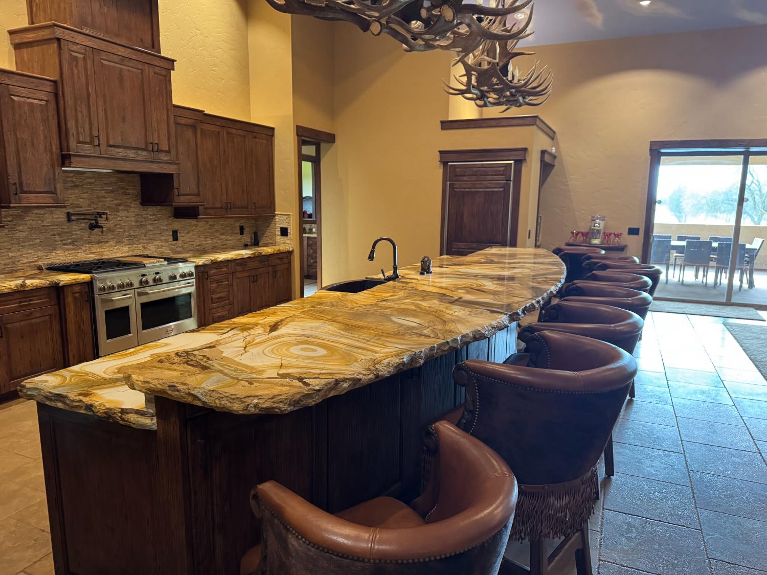 3488 River Road Colusa, CA 95932 - Photo 7 of 31 a kitchen with a stove a sink a dining table and chairs