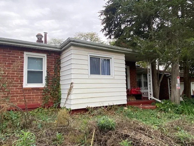 a view of a house with a yard and stairs