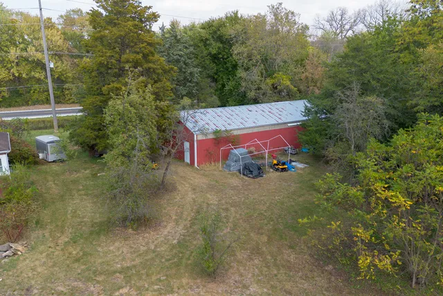 a yellow building with trees in the background