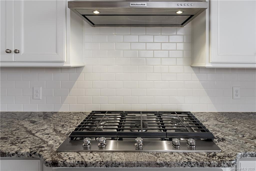 1009 Castle Road Indian Land, SC 29707 - Photo 14 of 37 a close view of a stove a microwave and cabinets