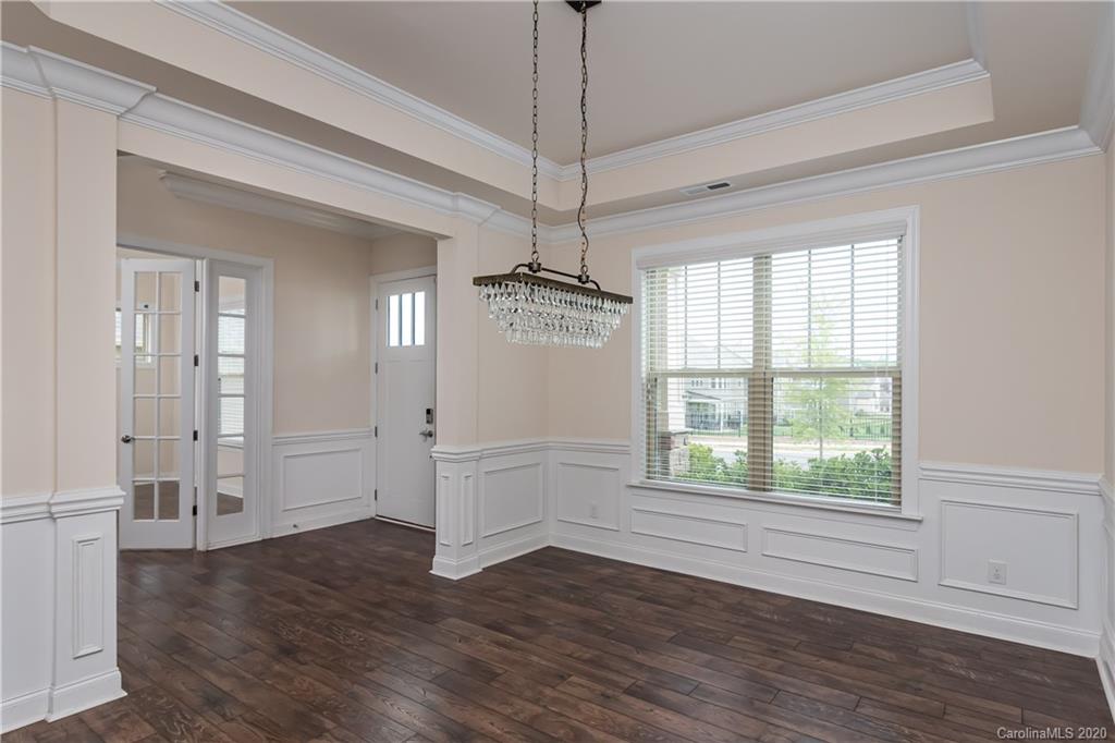 1009 Castle Road Indian Land, SC 29707 - Photo 8 of 37 a view of an empty room with wooden floor and a window