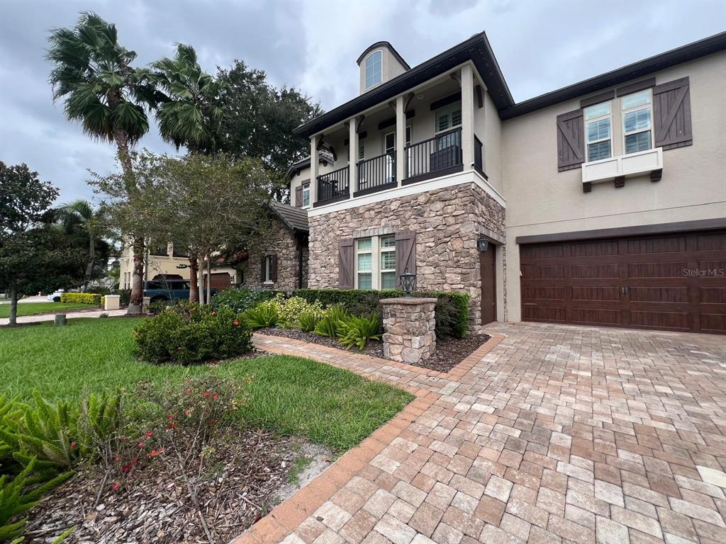 12927 Canopy Woods Way Winter Garden, FL 34787 - Photo 3 of 41 a front view of a house with a yard and garage