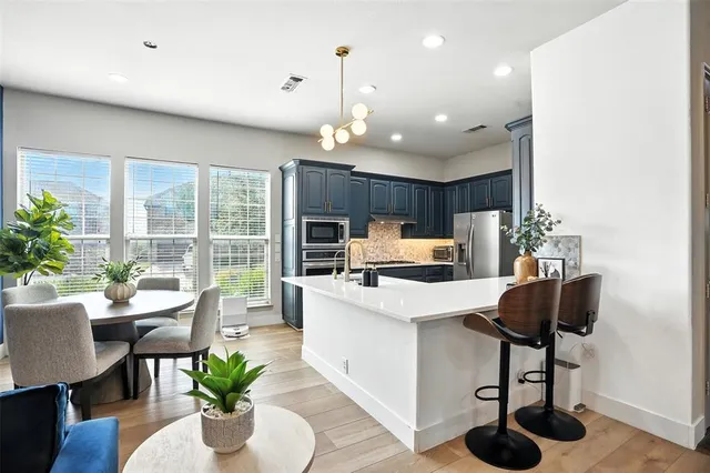 a kitchen with a table and chairs