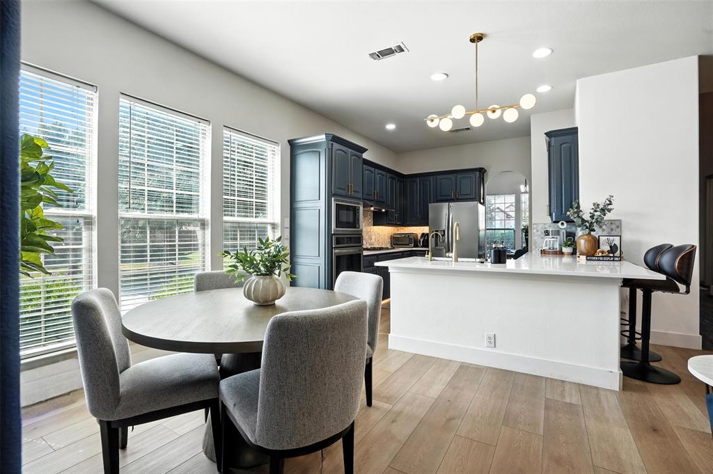 200 Thistle Ridge Denton, TX 76210 - Photo 13 of 31 a view of a dining room with furniture window and wooden floor