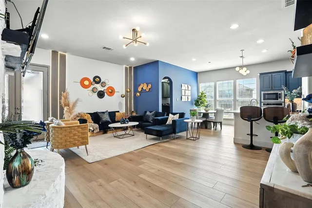 a living room with furniture and wooden floor