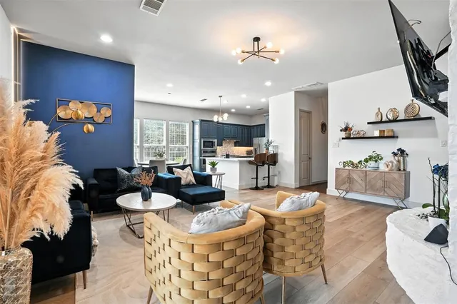 a living room with furniture and wooden floor