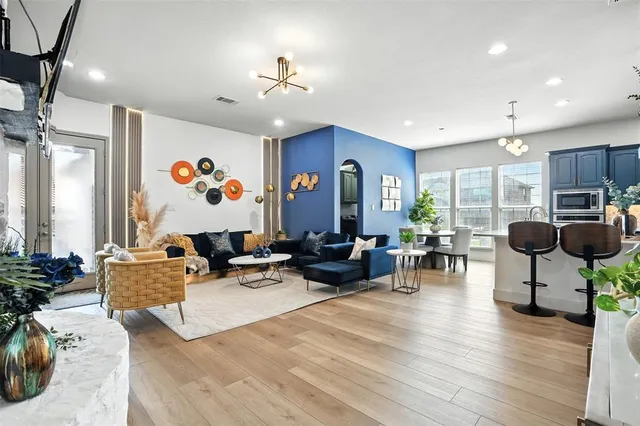 a living room with furniture and wooden floor